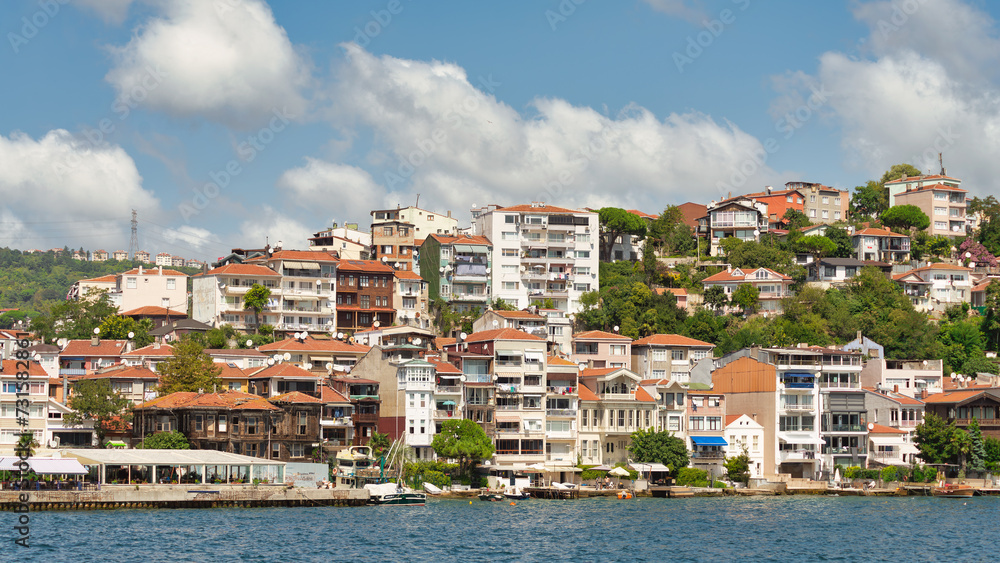 Morning view from the sea of the mountains of the Europian side of Bosphorus strait, with traditional houses and dense trees in a summer day, Istanbul, Turkey