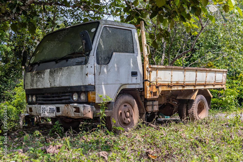 An old truck is parked in nature An old truck is parked in nature