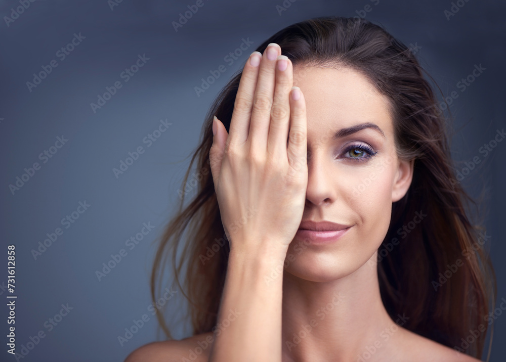 Makeup, smile and hand on face of woman in studio for beauty, comparison or makeover on grey background. Half, portrait and female model with glowing skin, wellness or glamour treatment results Makeup, smile and hand on face of woman in studio for beauty, comparison or makeover on grey background. Half, portrait and female model with glowing skin, wellness or glamour treatment results