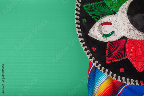 Mariachi hat and serape on green background. Mexican independence concept. Cinco de mayo background.