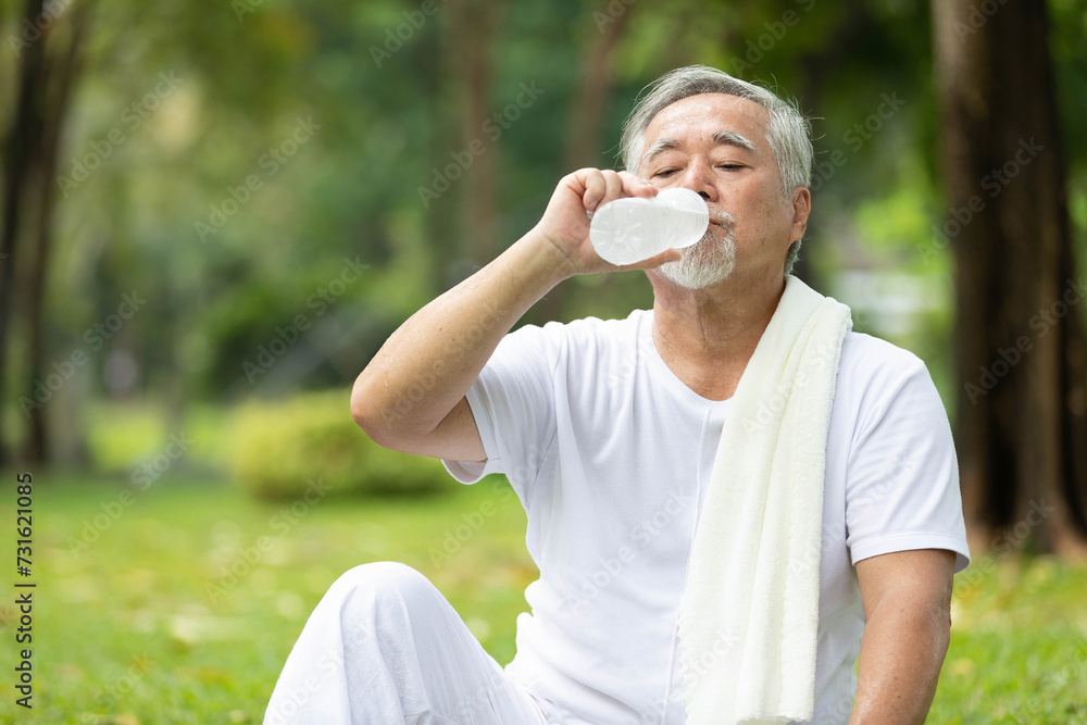senior man drinking water after workout or exercising in the park senior man drinking water after workout or exercising in the park