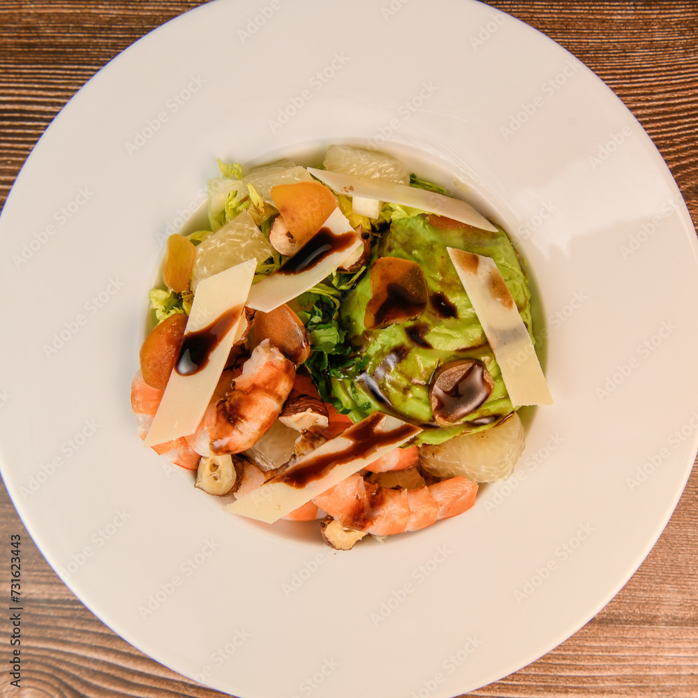 RECIPE FOR MIXED SALAD OF BOTTARGA AVOCADO SHRIMP CHINESE GRAPEFRUIT, SUCRINE SALAD, PARMESAN, HAZELNUT, BALSAMIC VINAIGRETTE. High quality photo