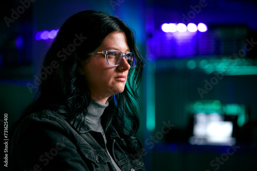 Close Up Of Female Computer Hacker Sitting In Front Of Screens Breaching Cyber Security