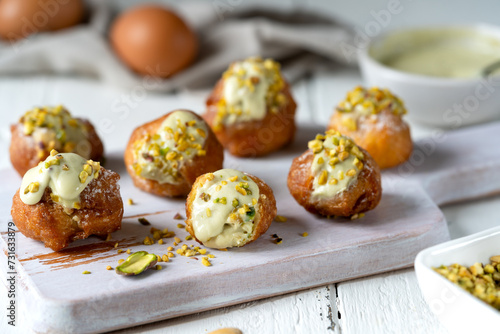 Frittelle di Carnevale with Pistachio Cream and Chopped Nuts photo