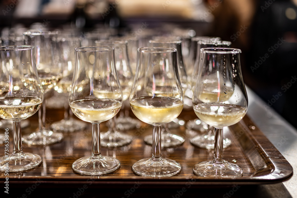 Many small tasting glasses of sparkling wine champagne on winter festival in December, Avenue de Champagne, Epernay, Champagne region, France Many small tasting glasses of sparkling wine champagne on winter festival in December, Avenue de Champagne, Epernay, Champagne region, France