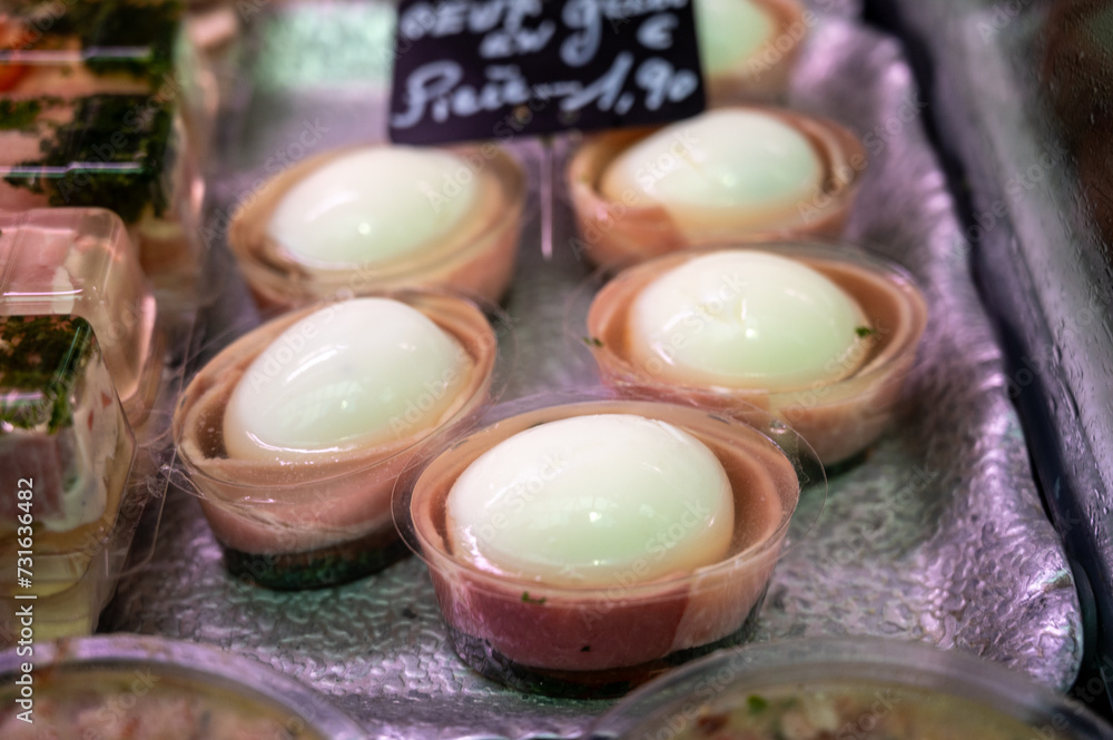 Assortment of meat on weekly food market in France, English translation: chicken eggs in jelly