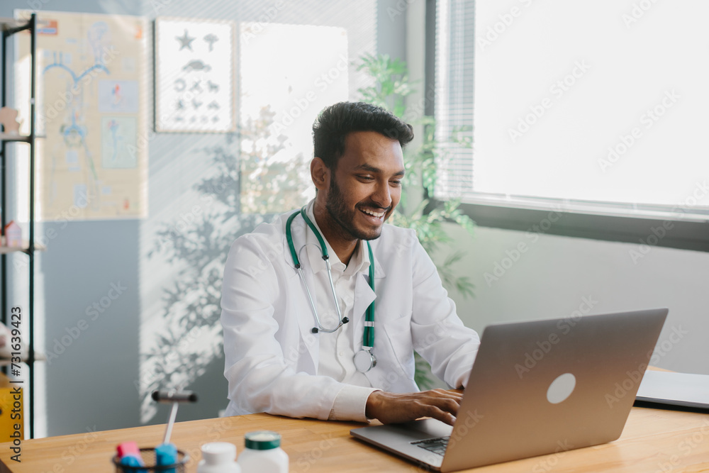 An Asian doctor uses a laptop to conduct an online consultation with a patient. An Asian doctor uses a laptop to conduct an online consultation with a patient.