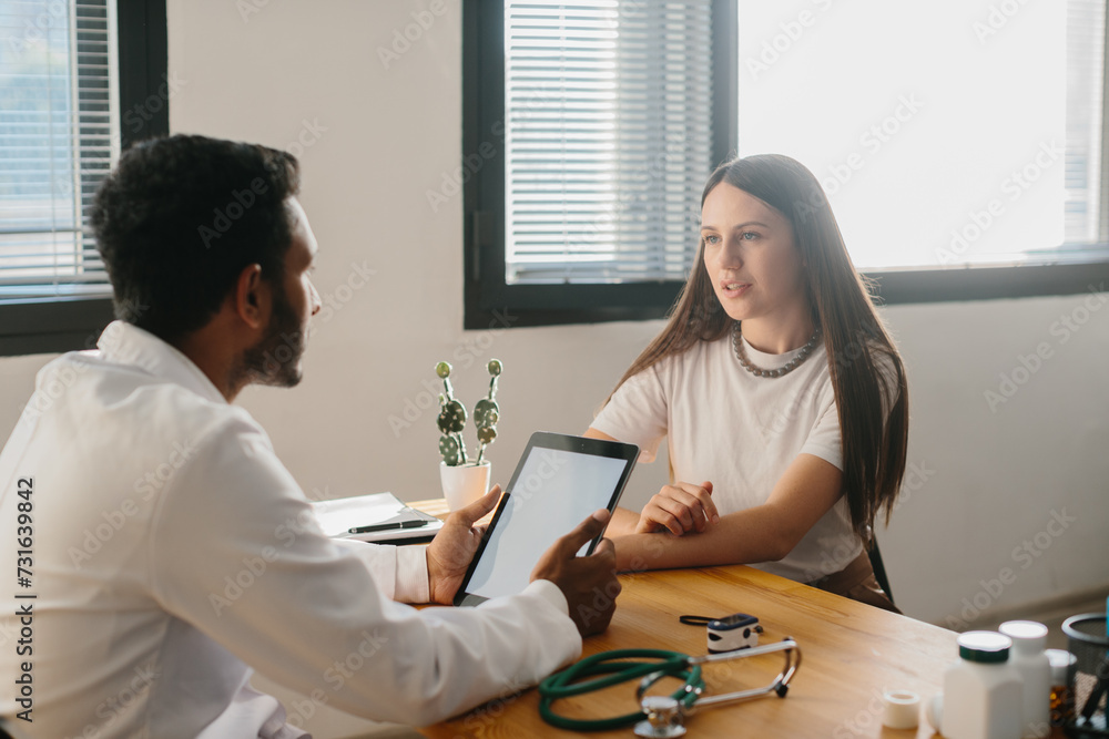 Fototapeta premium A young woman at an appointment with a family doctor.