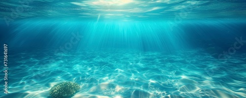 Serene underwater scene showcasing beams of sunlight filtering through the ocean's surface © mendor