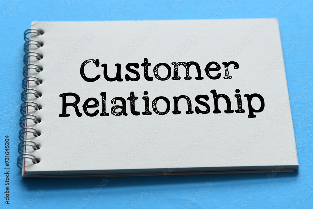 Customer relationship words in office notebook on blue table. Customer relationship words in office notebook on blue table.