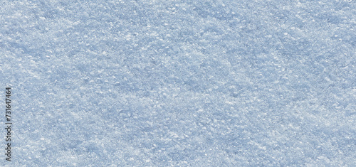 Surface of natural snow close-up. Blue snow background with small ice crystals