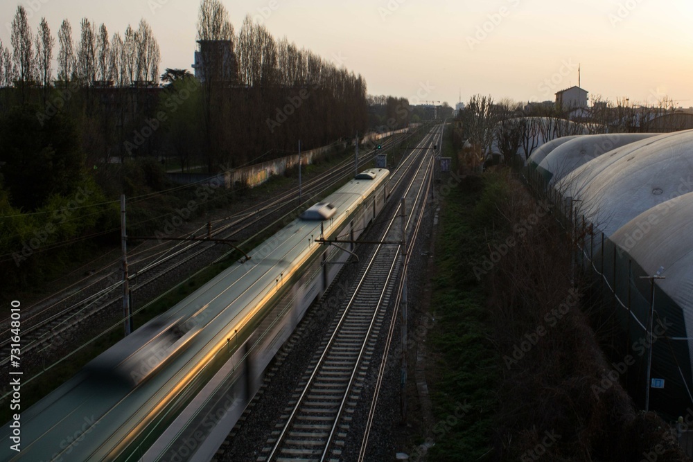 evocative image of the panoramic view of the train tracks from an elevated road in Italy
