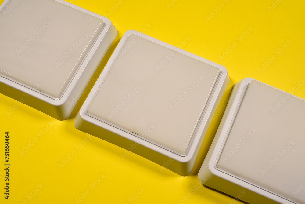 White led square led lamps on the yellow flat lay background with copy space. White led square led lamps on the yellow flat lay background with copy space.