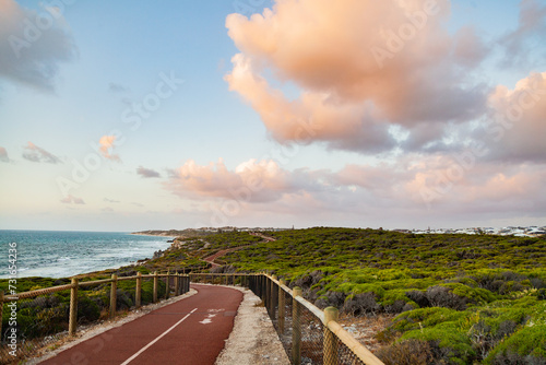 Iluka coastal walk at sunset, walking path between natural coastal vegetation photo