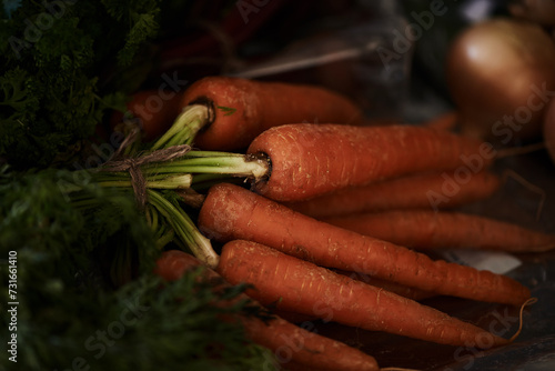 Closeup, carrot and food for health and cooking, wellness and nutrition with vegan or vegetarian meal prep. Orange vegetables, organic produce and cuisine with dinner or lunch ingredients for diet © peopleimages.com