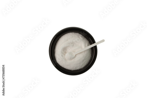 Sodium erythorbate or Sodium isoascorbate in black ceramic dish with measuring spoon, top view. Food additive E316 with chemical formula C6H7NaO6.White crystalline powder