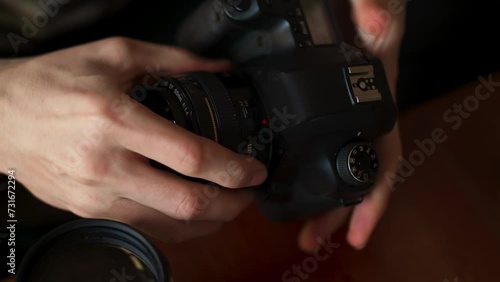 The photographer sets the lens on the SLR camera. Photographer Remote Workspace Amidst Oriental Elegance