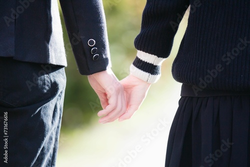 Back view of a couple in uniforms holding hands