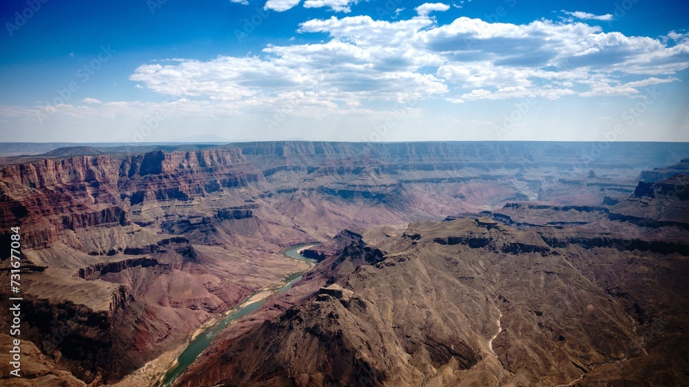 Drone view of a river in the Grand Canyon in the United States under blue cloudy sky