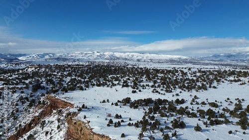 Canvas Print Aerial view of snow covered mountain landscape under blue sky