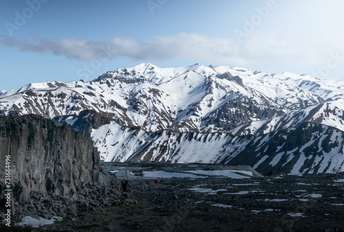 there is an image of a snow covered mountain range near the water