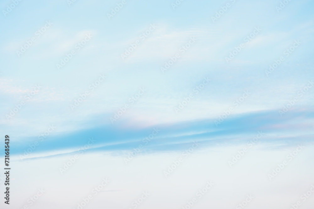 Fototapeta premium A beautiful sky tinted by the sun leaving vibrant shades of gold, pink, blue and multicolored. Clouds in the twilight evening and morning sky. Cloudy sky background in the evening and during the day.