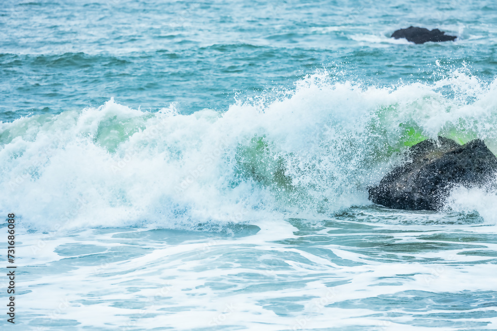 Fototapeta premium Wave splashing close-up. Crystal clear sea water, in the ocean in San Francisco Bay, blue water, pastel colors.