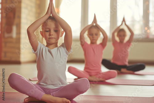 
yoga class for kids. health care concept. beautiful children doing yoga in a bright room