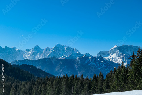 Scenic view of snowcapped mountain peaks of Julian Alps seen from Dreilaendereck, Karawanks, Carinthia, Austria. Hiking in remote alpine landscape in early springtime in Austrian Alps. Wanderlust