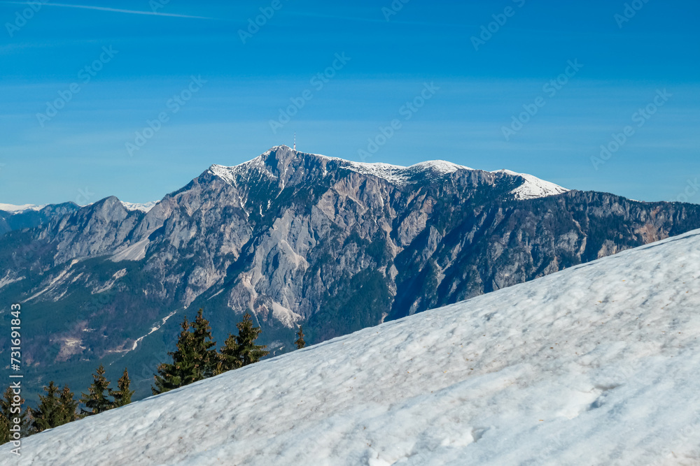 Panoramic view of majestic mountain peak Dobratsch seen from Dreilaendereck (Pec, Often, Monte Forno) in untamed Karawanks, Carinthia, Austria. Alpine landscape in spring in Austrian Alps. Wanderlust