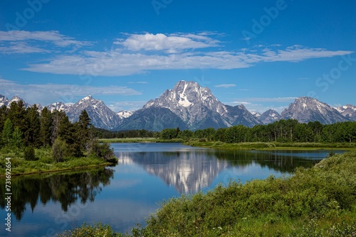 Fototapeta Naklejka Na Ścianę i Meble -  Scenic view of the majestic Grand Teton Mountains reflected in the tranquil waters of a lake