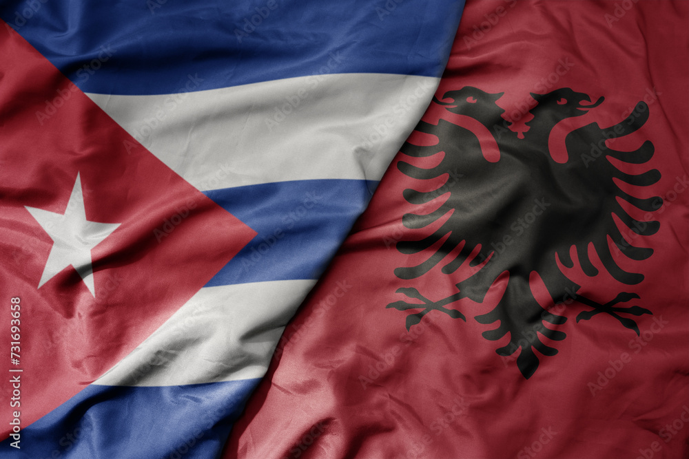 big waving national colorful flag of albania and national flag of cuba . big waving national colorful flag of albania and national flag of cuba .