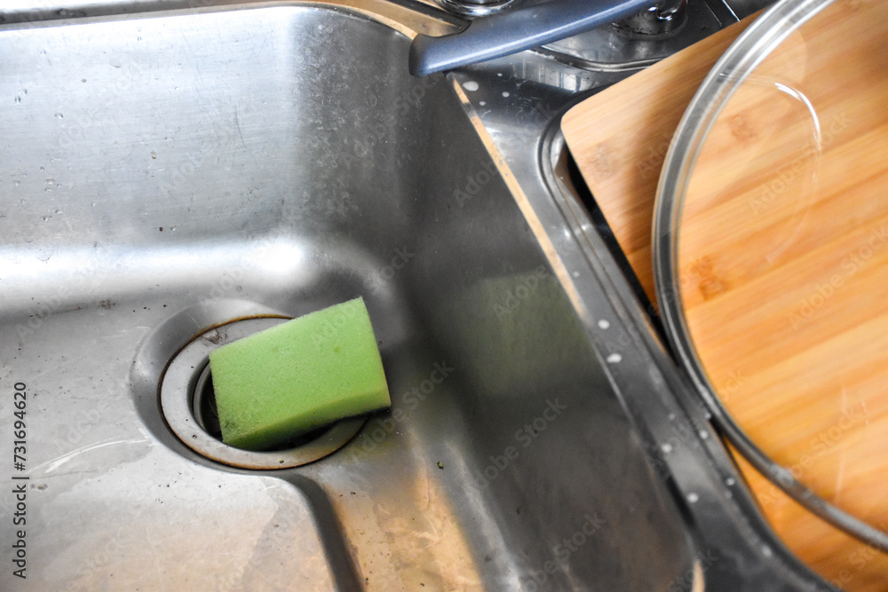 Kitchen equipment. Glass lid for the pan, bamboo cutting board. Washed dishes. A mess in the kitchen Kitchen equipment. Glass lid for the pan, bamboo cutting board. Washed dishes. A mess in the kitchen