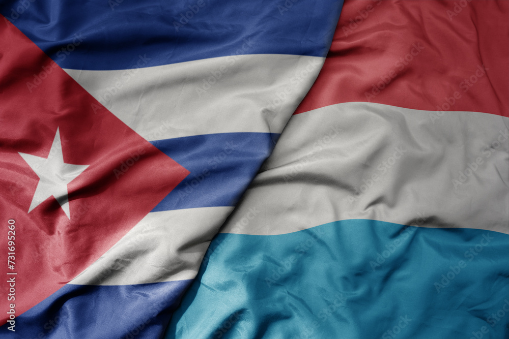 big waving national colorful flag of luxembourg and national flag of cuba . big waving national colorful flag of luxembourg and national flag of cuba .