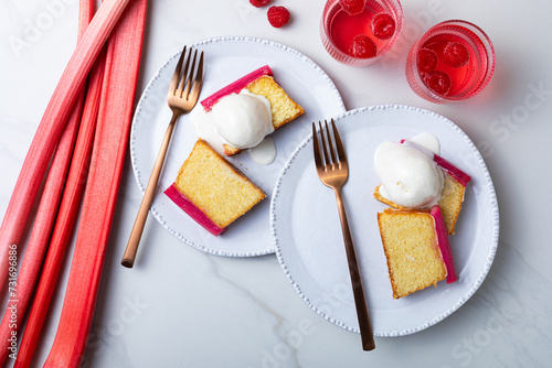 Fresh loaf cake decorated with roasted rhubarb. Sweet and delicious rhubarb dessert with ice cream