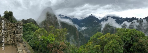 Panoramic view of the breathtaking mountains on the background of a green forest on a cloudy day