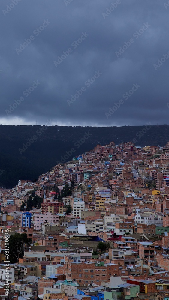Vertical shot of the colorful buildings in La Paz on a cloudy day. Bolivia.