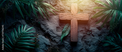Wood cross and palm leaves over stone background for easter. Catholicism symbol.