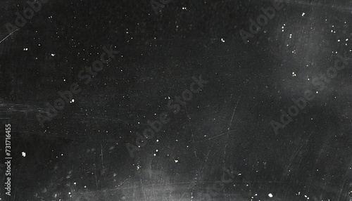 A dark, scratched surface background scattered with white specks.