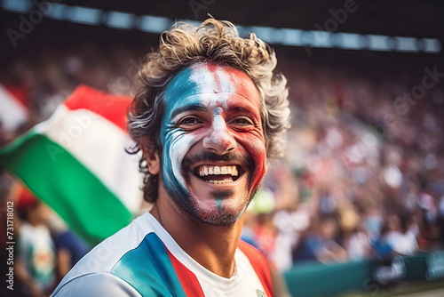 man soccer fun with painted face of flag Italy in football stadium
