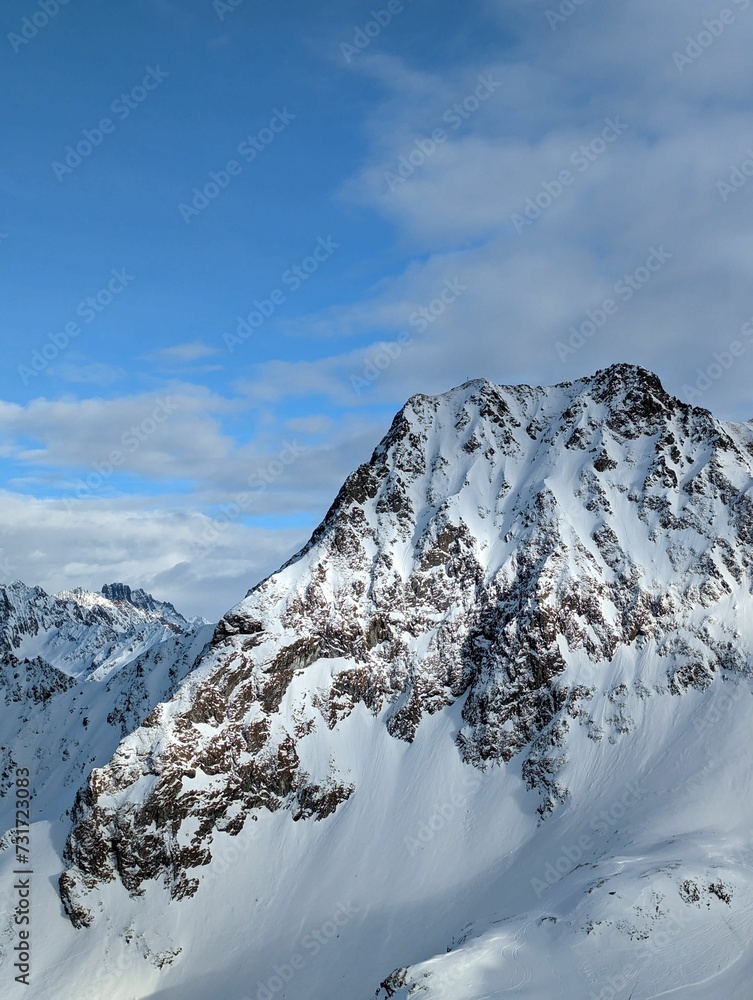 Vertical shot of a scenic view of a snow covered mountain peak