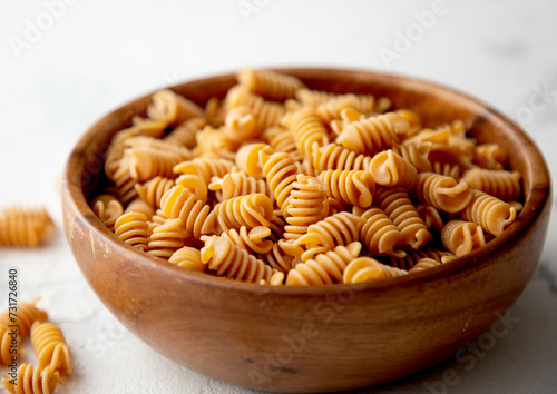 Organic Italian Chickpea Fusilli Pasta in a Wooden Bowl. Gluten-Free, Grain-Free, and Vegan Pasta. Healthy Eating Concept. View from Above.