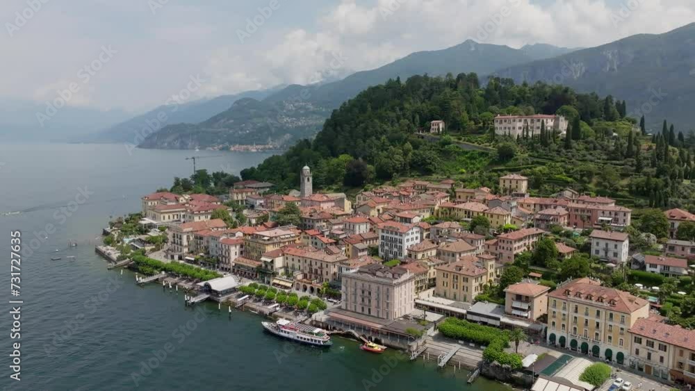 Drone shot over Como lake with view of Bellagio town and forested hill Drone shot over Como lake with view of Bellagio town and forested hill