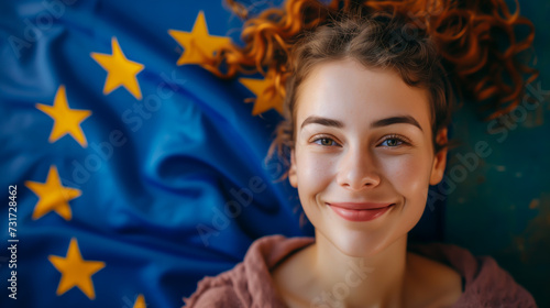 Young woman with the EU flag in the background. Concept of Schengen via and studying in the European Union. photo