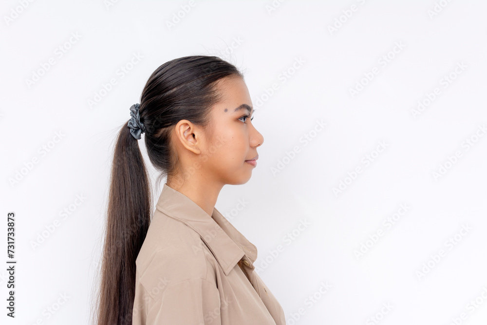 A poised young Filipino woman in profile view, isolated on a clear white background, exuding a subtle confidence. A poised young Filipino woman in profile view, isolated on a clear white background, exuding a subtle confidence.