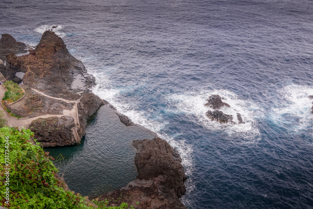 Coastal rocks embrace the sea.