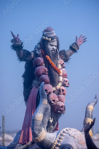 Masan Holi, Portrait of an male artist act as lord shiv with dry ash on face and body also in air while celebrating the masan holi as tradition at Harishchandra ghat in varanasi, India.