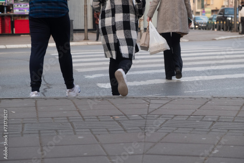 People crossing the street in the city, closeup of legs and shoes  © DaliCeMedia