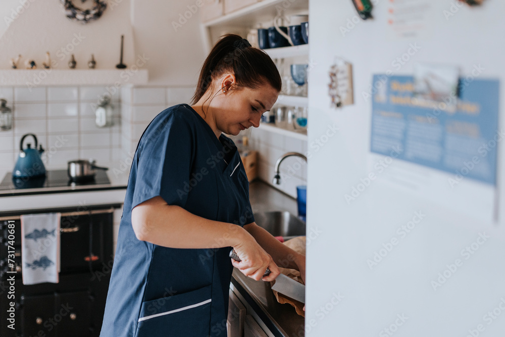 In-home nurse preparing food in kitchen In-home nurse preparing food in kitchen