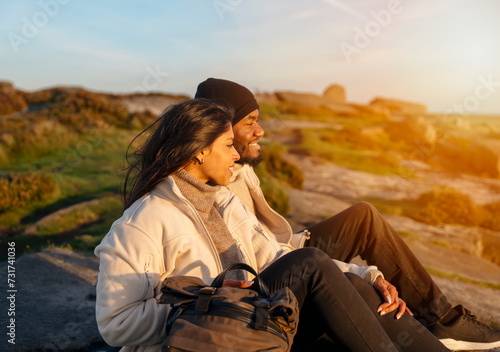 happy couple in love walking along countryside at the sunset. Love, hiking and active lifestyle concept